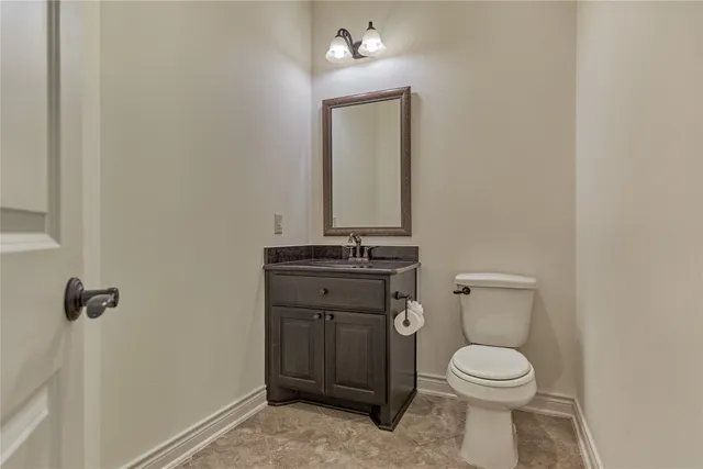 a bathroom with a toilet a sink and mirror
