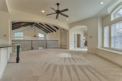 a view of a livingroom with a ceiling fan and window