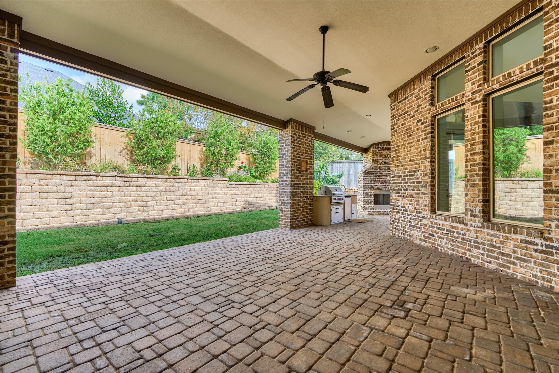 108 Evergreen Oak Drive Conroe, TX 77384 - Photo 43 of 45 This covered patio wraps the whole back of the house with access from den and primary allowing you to create an eating zone & lounge area with couches.