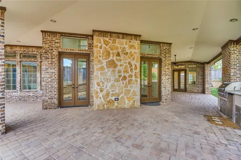 a view of a big room with wooden floor and windows