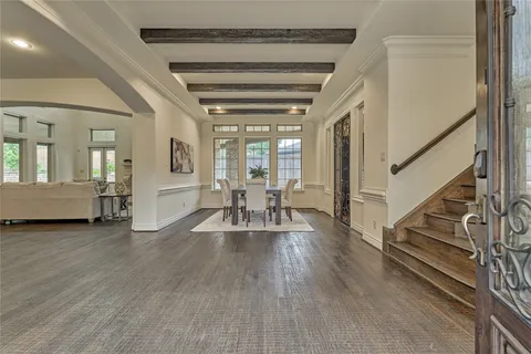 a view of a livingroom with wooden floor and furniture