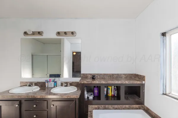 a bathroom with a granite countertop sink and a toilet
