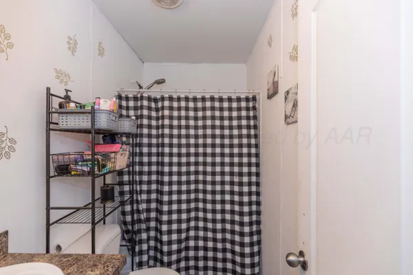 a bedroom with furniture and a book shelf
