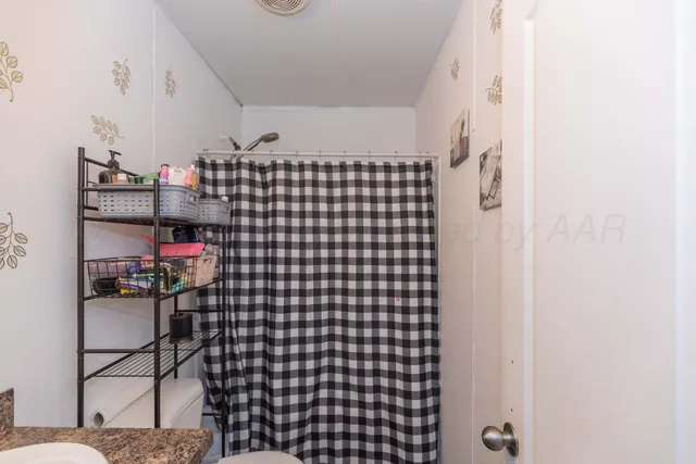 a bedroom with furniture and a book shelf