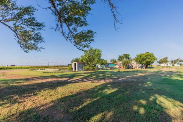 a view of yard with swimming pool and green space