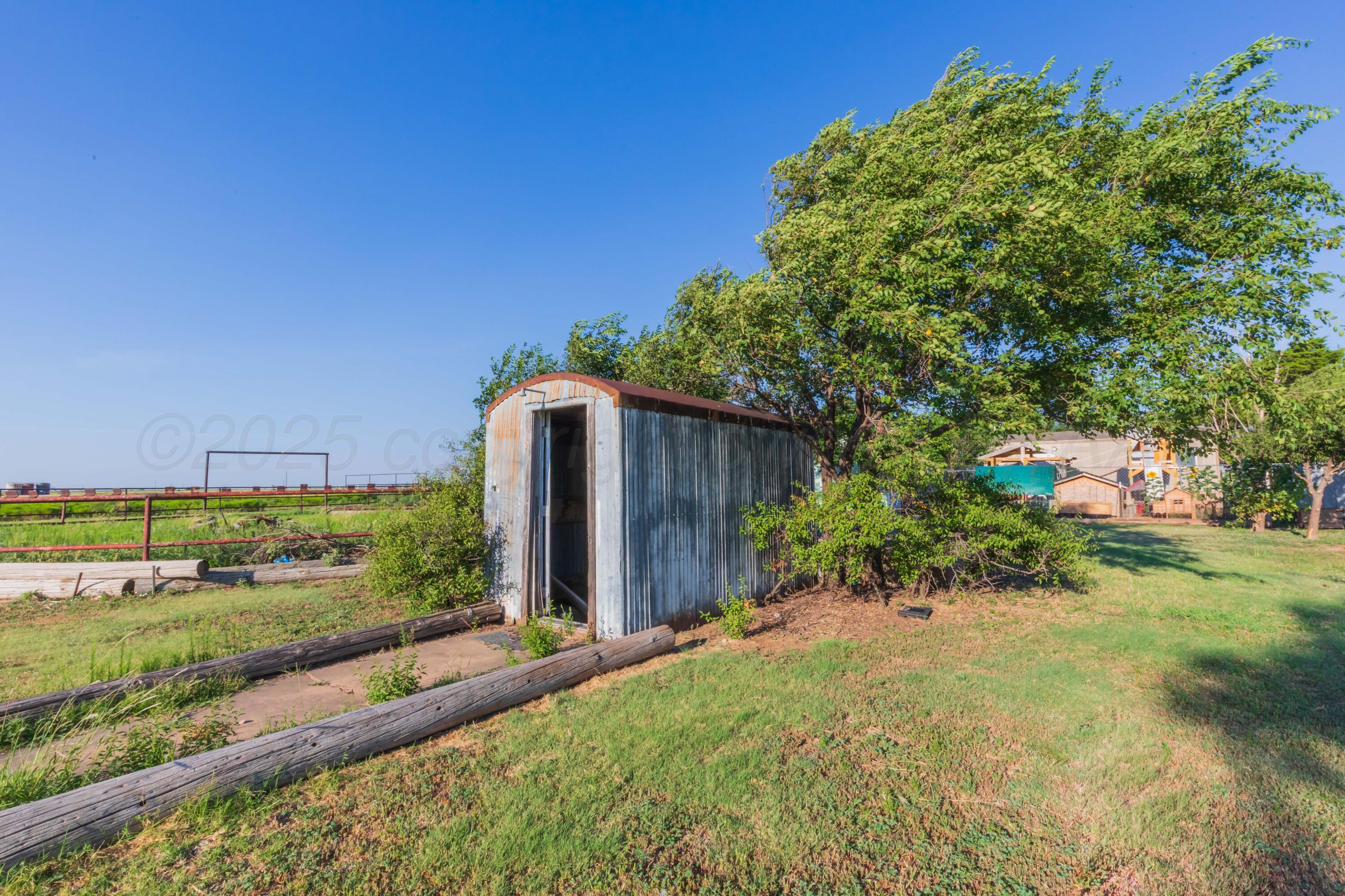 11566 County Road East Pampa, TX 79065 - Photo 33 of 56 a view of backyard with potted plants and wooden fence