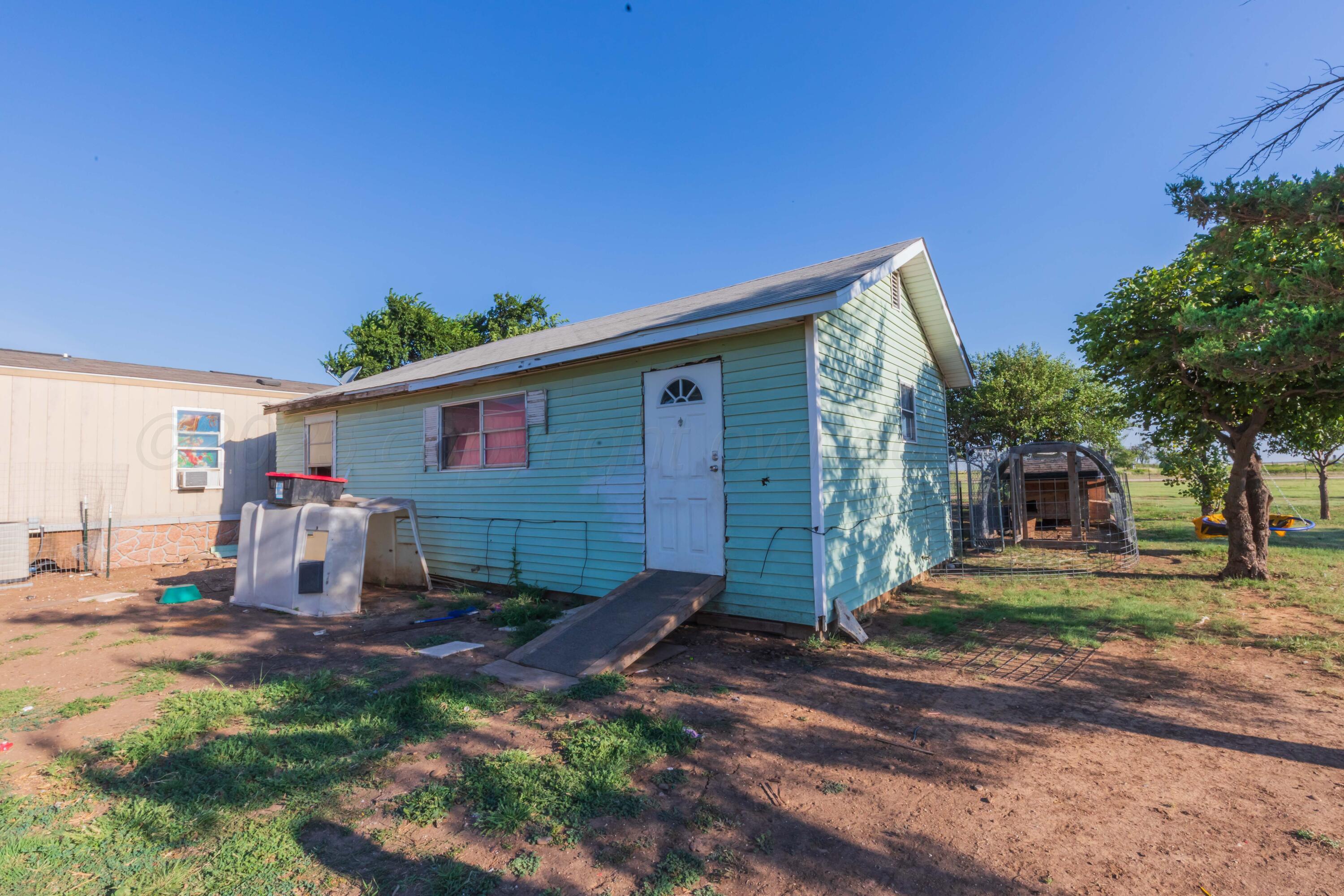 11566 County Road East Pampa, TX 79065 - Photo 42 of 56 a view of a house with backyard and trees