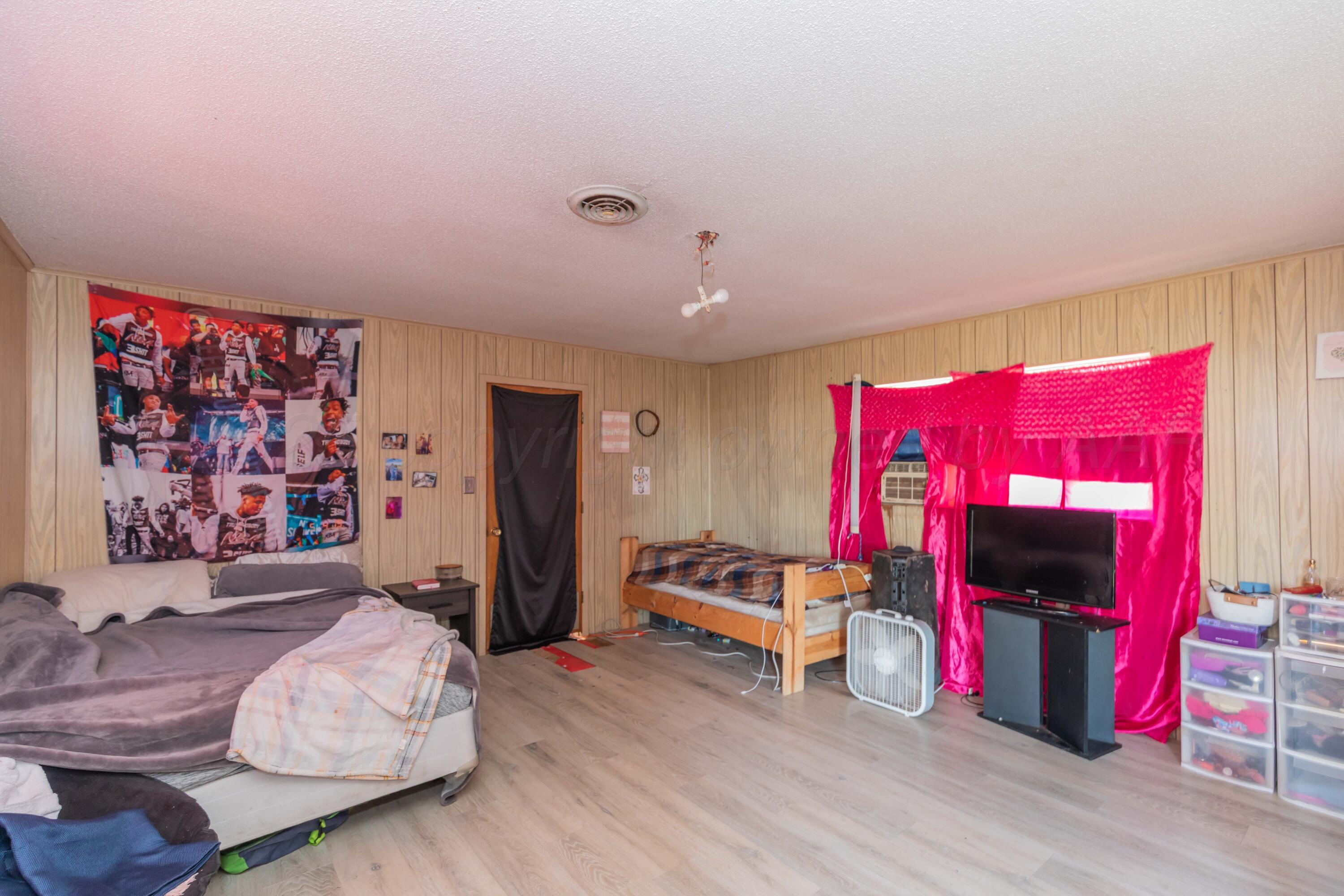 11566 County Road East Pampa, TX 79065 - Photo 43 of 56 a bedroom with furniture and a bed