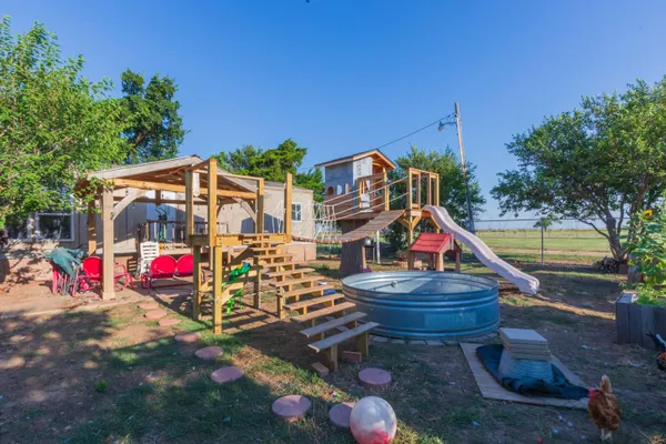 a view of a house with a yard and sitting area