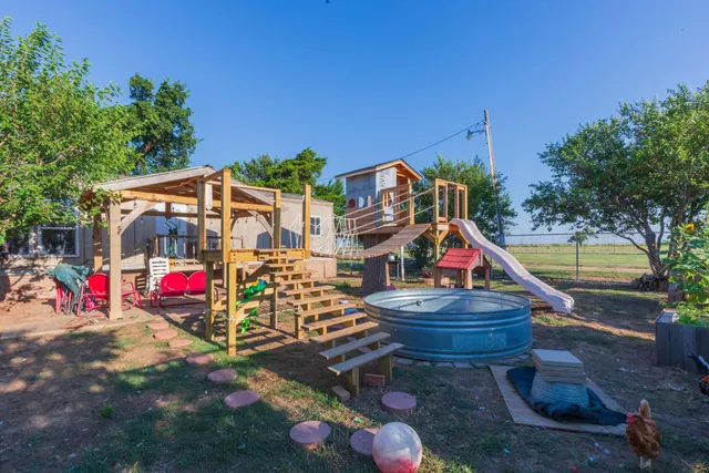 a view of a house with a yard and sitting area