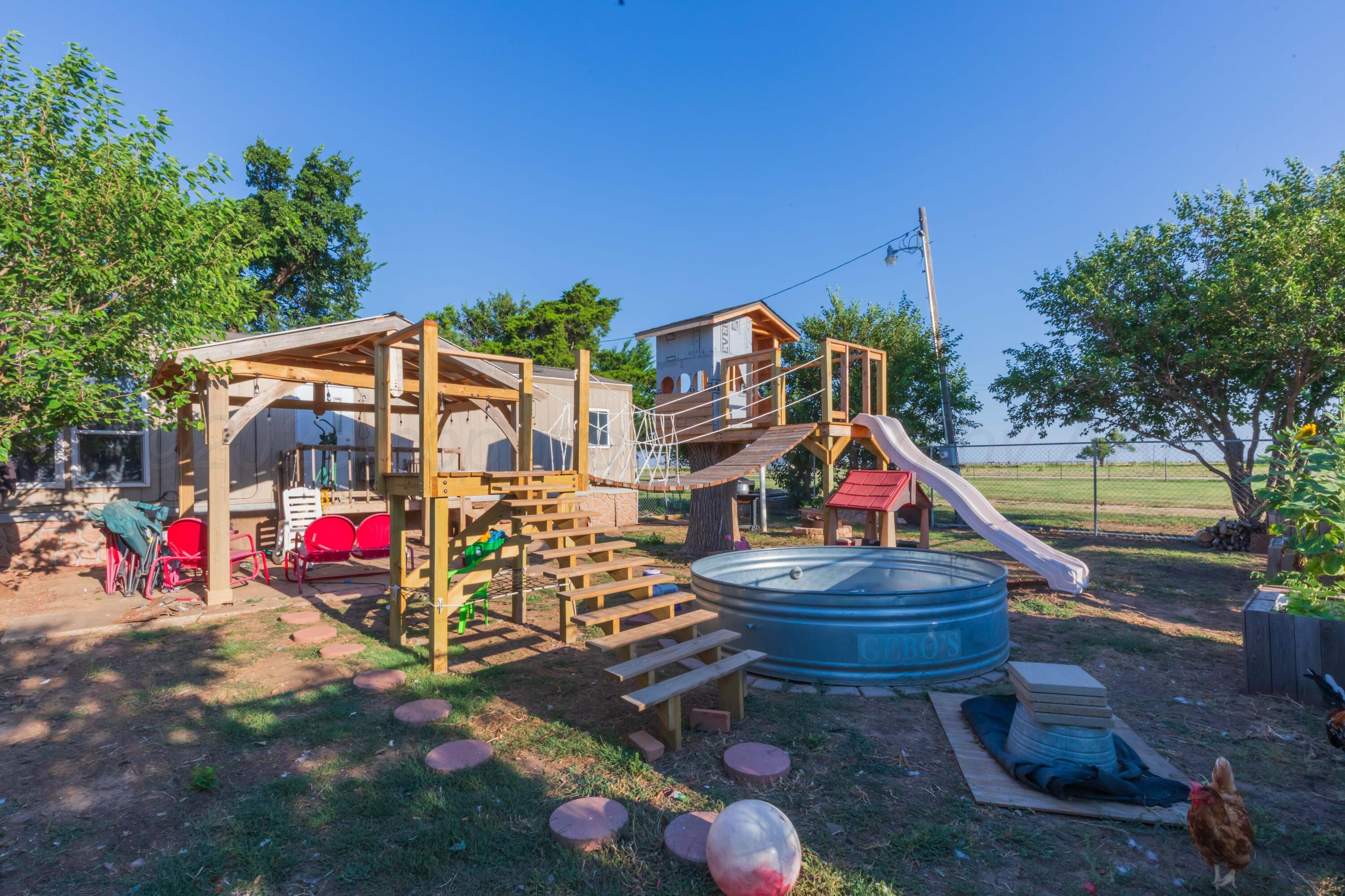 11566 County Road East Pampa, TX 79065 - Photo 49 of 56 a childrens park with lots of swings slides and swimming pool in the back