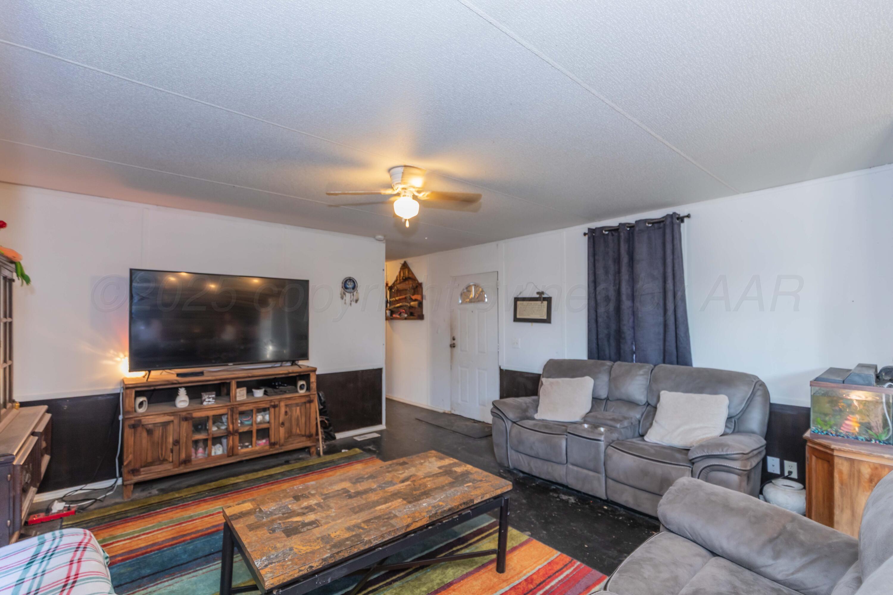 11566 County Road East Pampa, TX 79065 - Photo 5 of 56 a living room with furniture and a flat screen tv