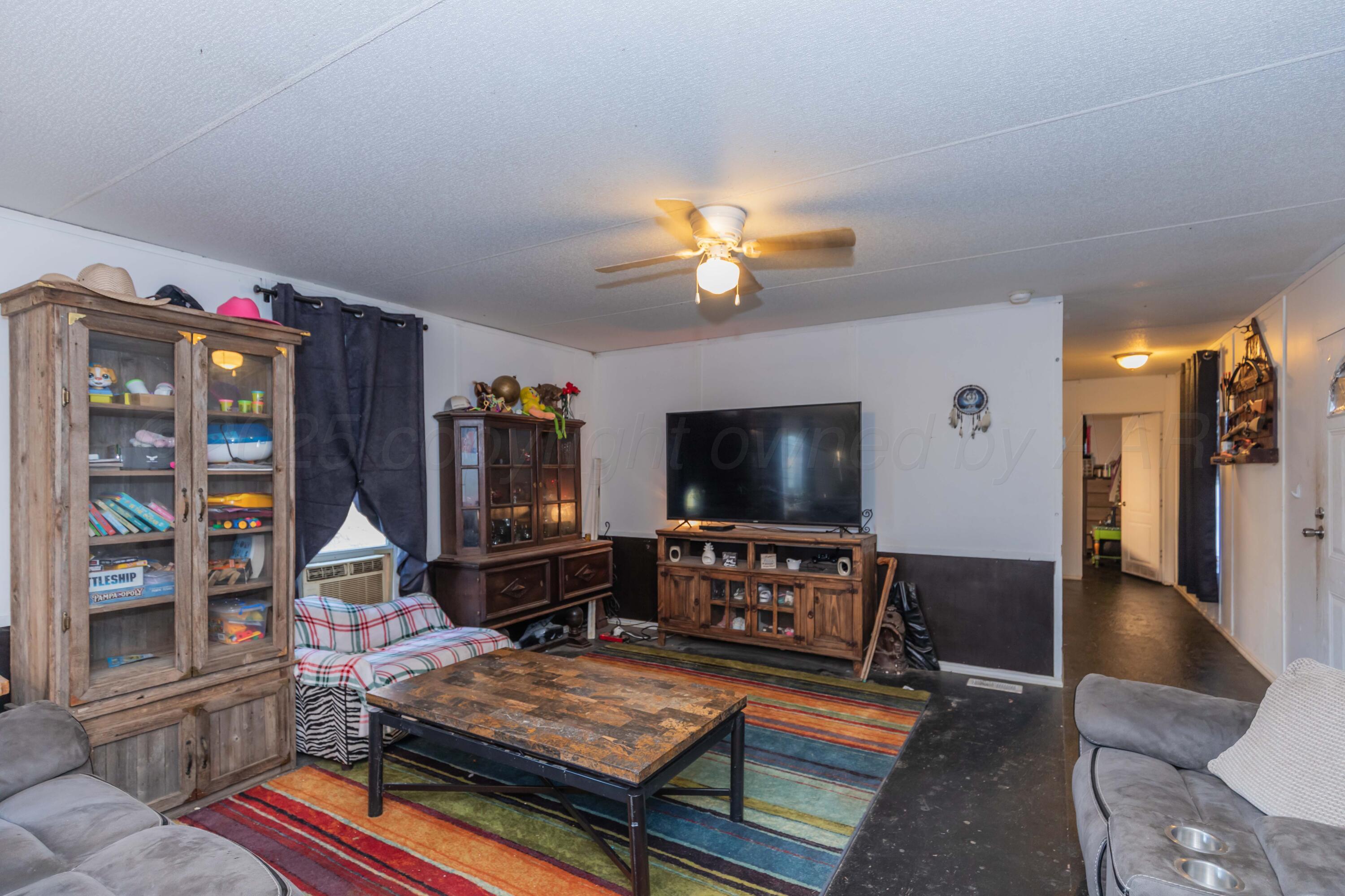 11566 County Road East Pampa, TX 79065 - Photo 6 of 56 a living room with furniture and a flat screen tv