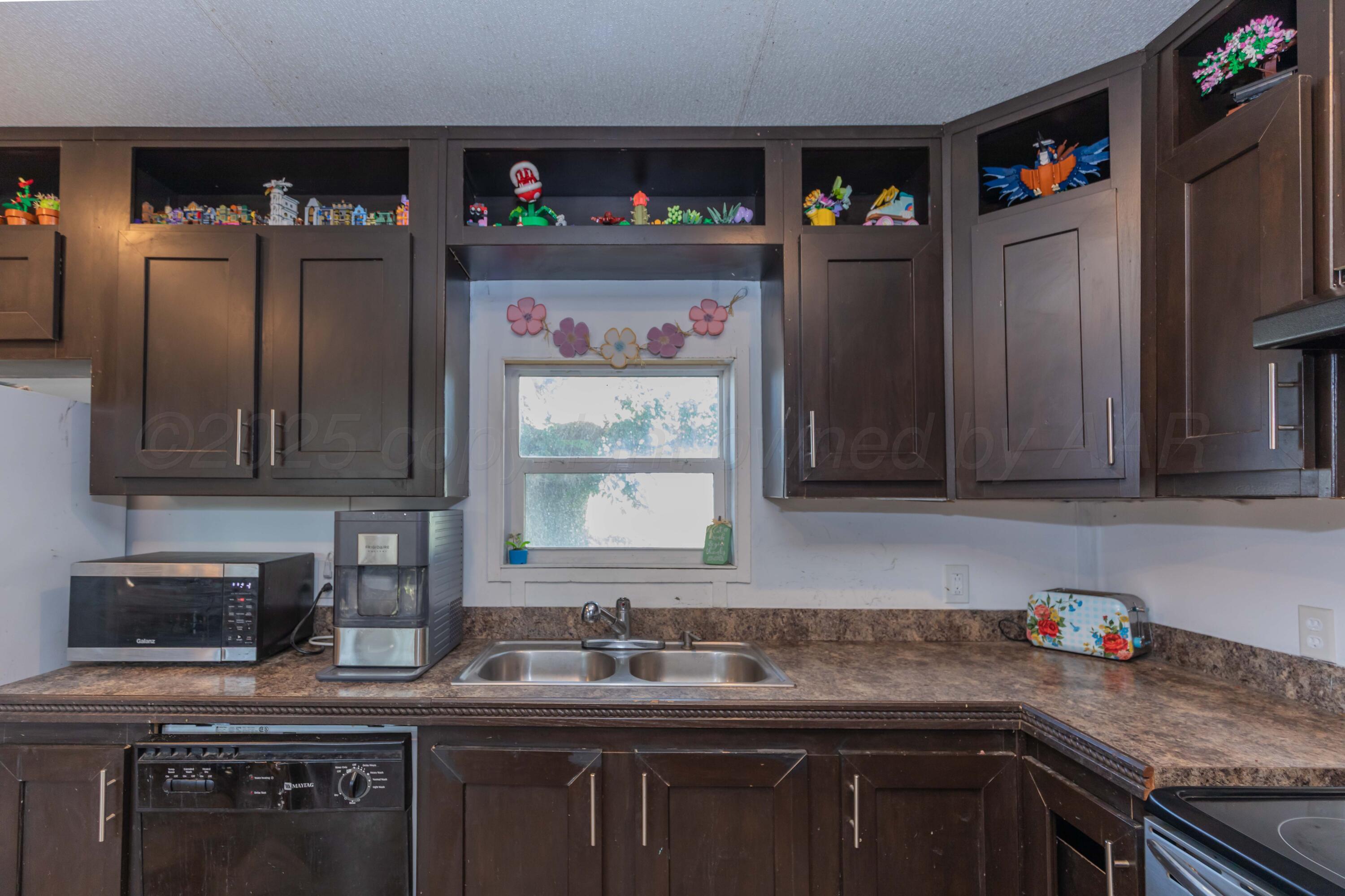 11566 County Road East Pampa, TX 79065 - Photo 8 of 56 a kitchen with stainless steel appliances granite countertop a sink stove and refrigerator