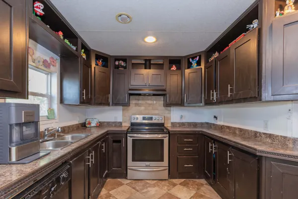 a kitchen with stainless steel appliances granite countertop a stove sink and cabinets
