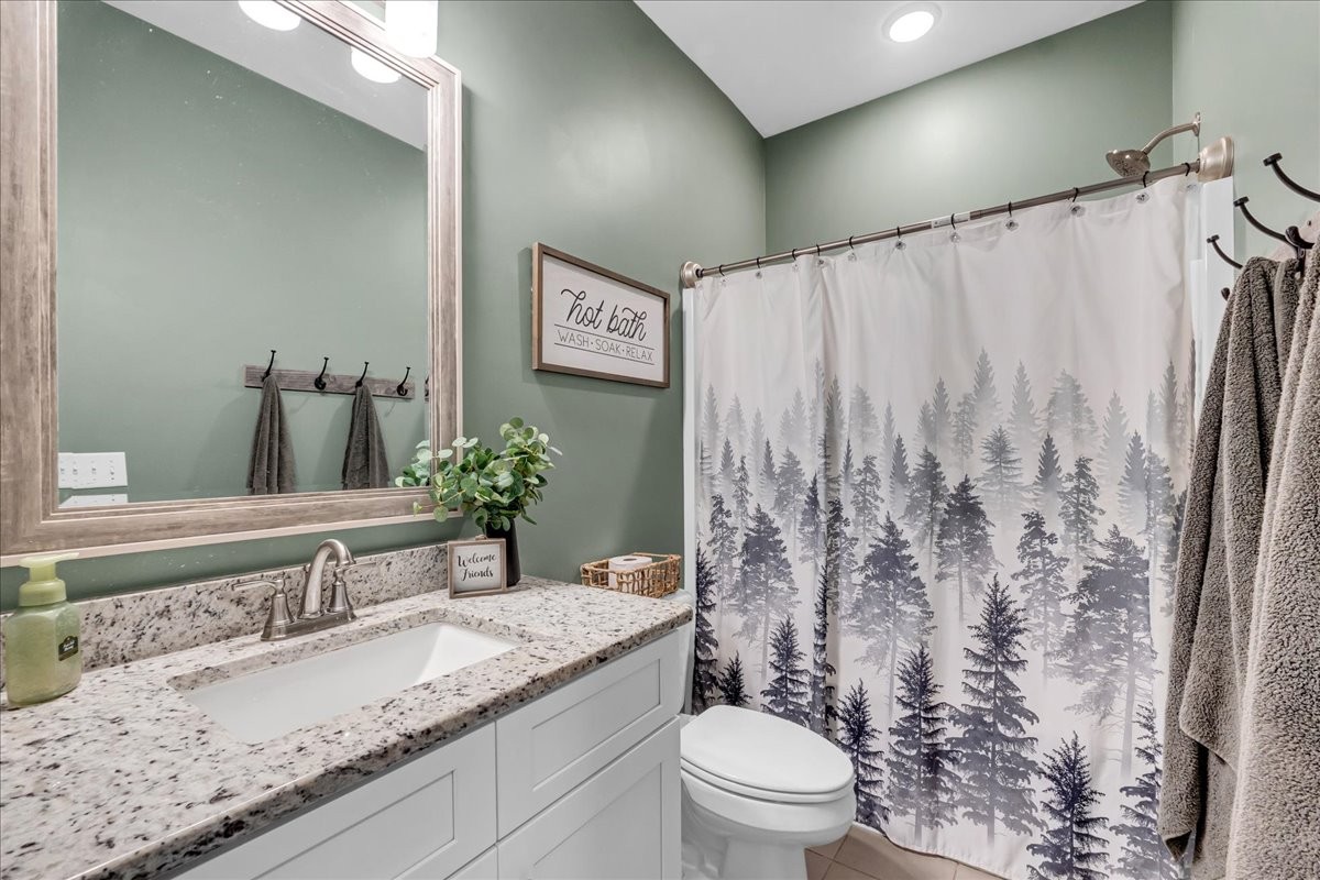 124 Cordell Love Road Smithville, TN 37166 - Photo 11 of 58 a bathroom with a granite countertop sink and a mirror