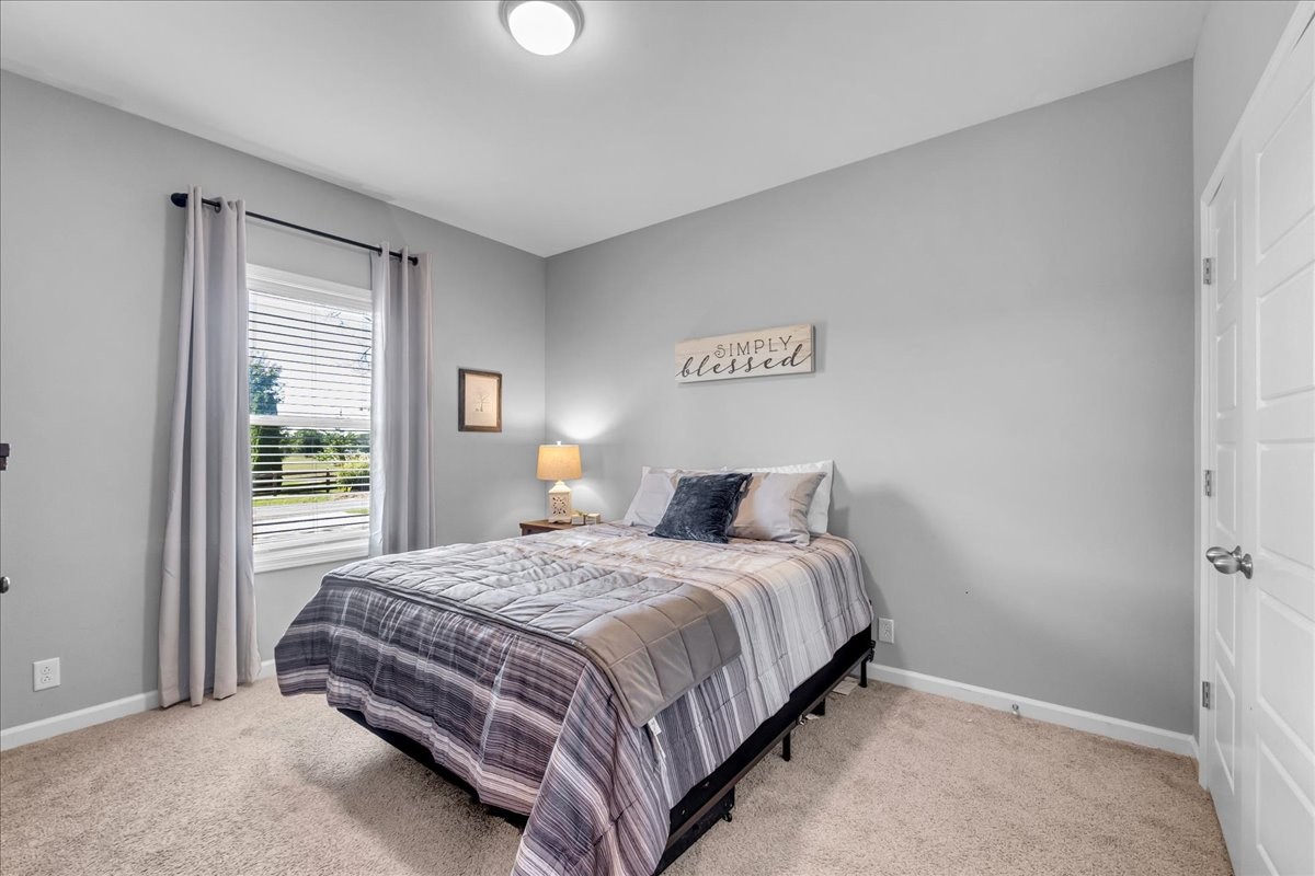 124 Cordell Love Road Smithville, TN 37166 - Photo 12 of 58 a bedroom with a bed lamp and window