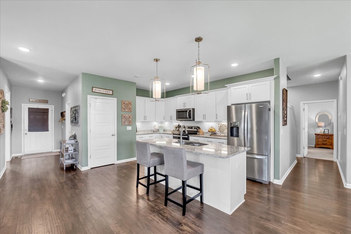 124 Cordell Love Road Smithville, TN 37166 - Photo 15 of 58 a kitchen with stainless steel appliances a refrigerator a stove top oven and a center island