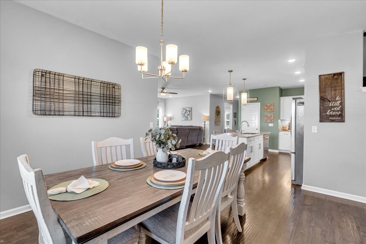 124 Cordell Love Road Smithville, TN 37166 - Photo 26 of 58 a view of a dining room with furniture wooden floor and chandelier
