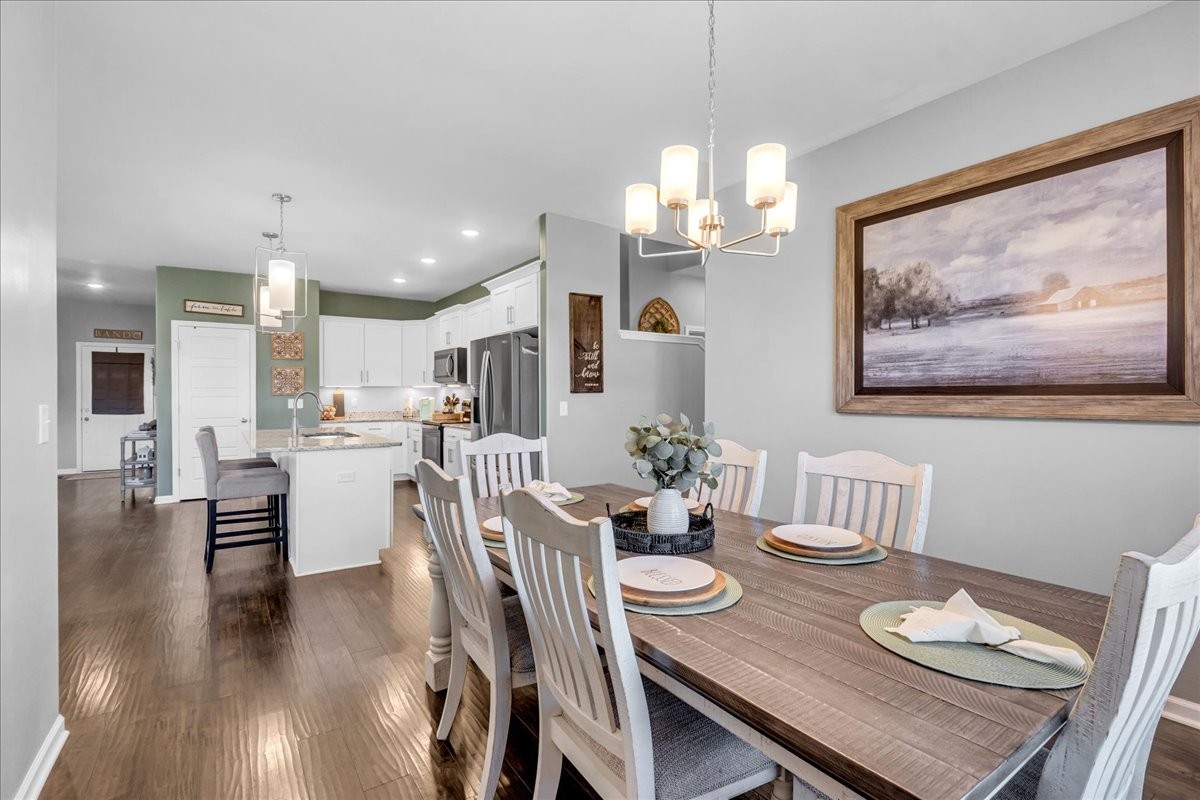 124 Cordell Love Road Smithville, TN 37166 - Photo 27 of 58 a view of a dining room with furniture wooden floor and chandelier