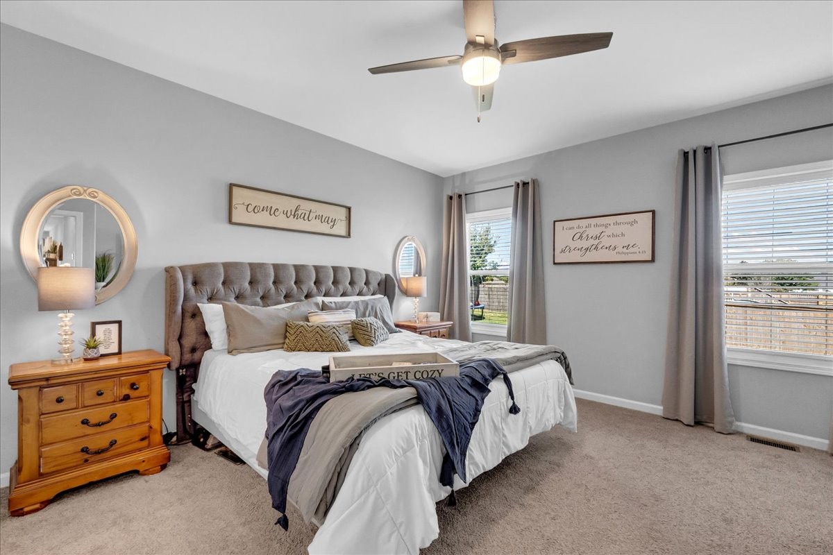 124 Cordell Love Road Smithville, TN 37166 - Photo 33 of 58 a bedroom with a bed and a chandelier
