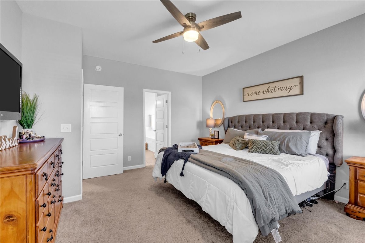 124 Cordell Love Road Smithville, TN 37166 - Photo 34 of 58 a bedroom with bed and a flat tv screen on dresser