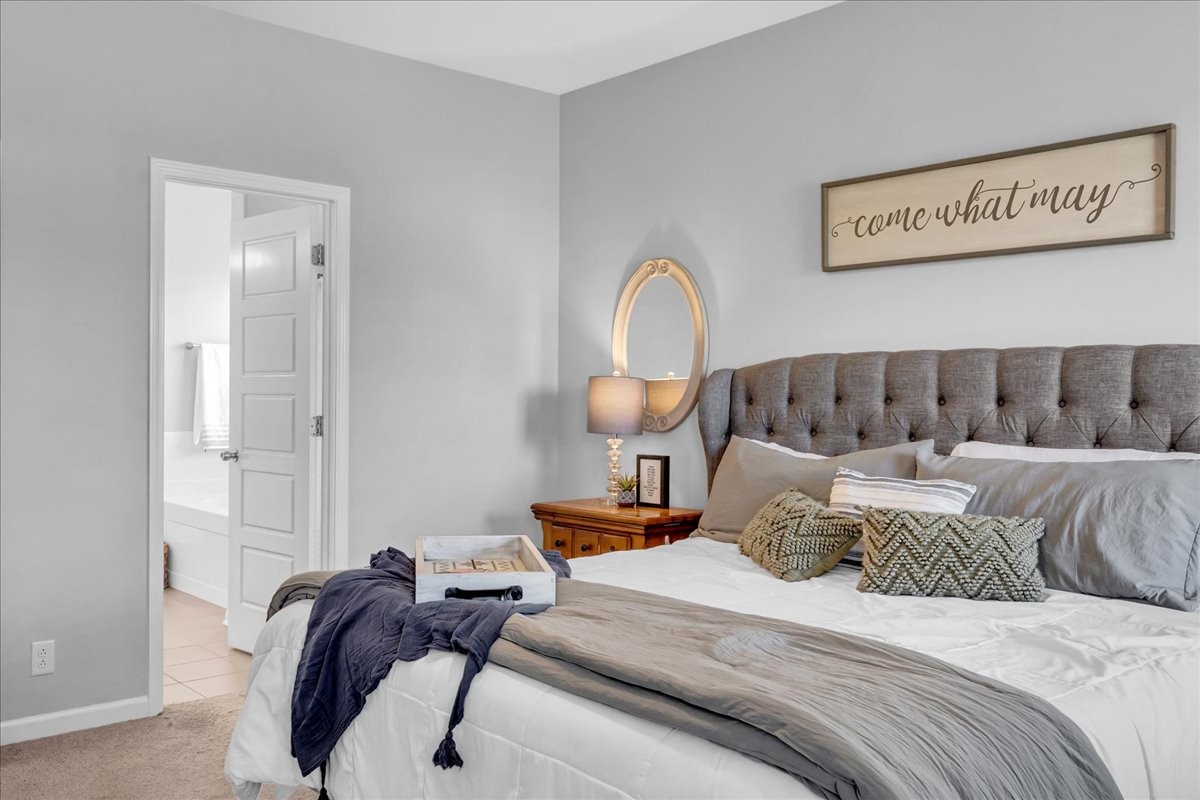 124 Cordell Love Road Smithville, TN 37166 - Photo 35 of 58 a bedroom with a bed and a lamp