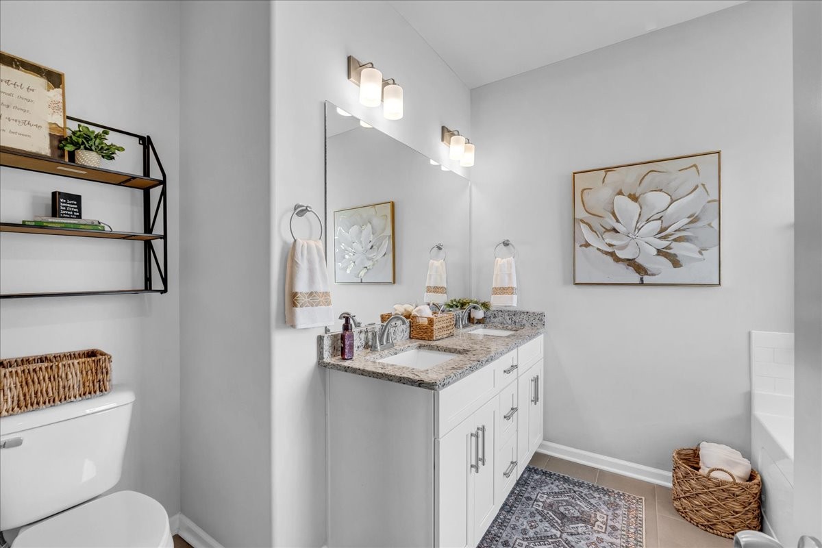 124 Cordell Love Road Smithville, TN 37166 - Photo 37 of 58 a bathroom with a double vanity sink toilet and a mirror