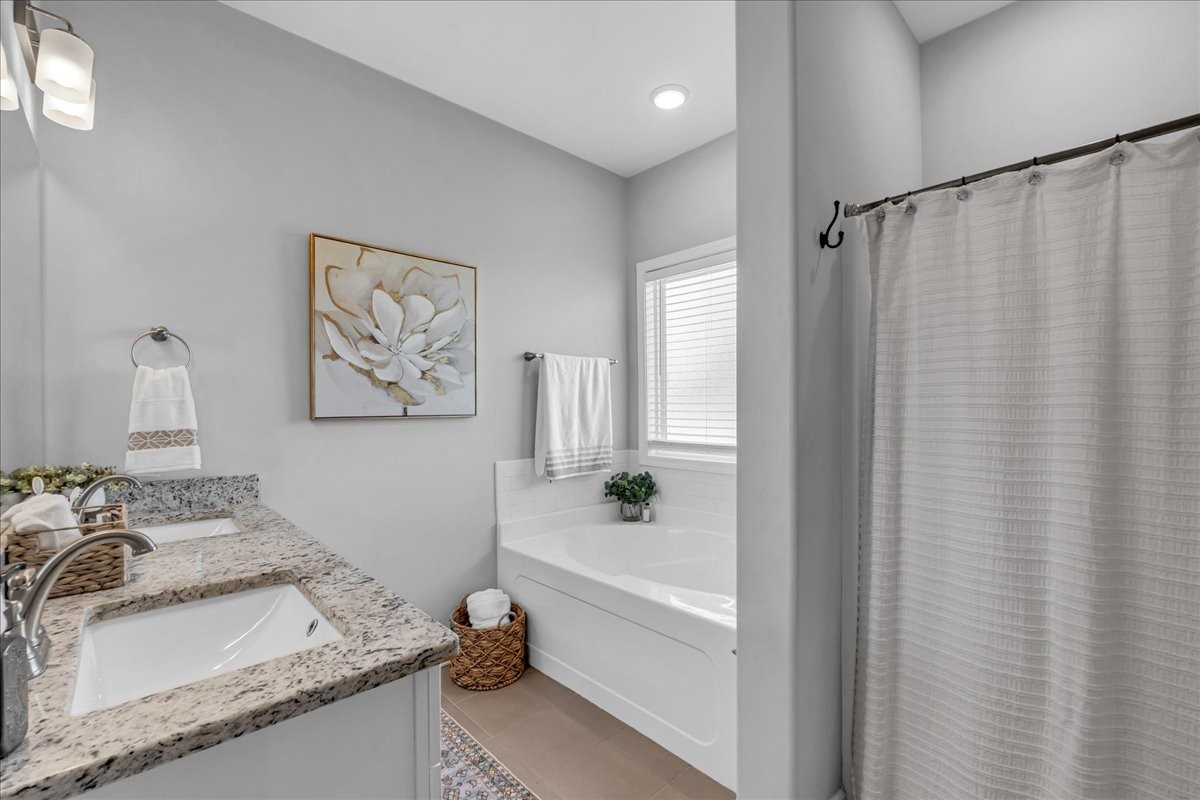 124 Cordell Love Road Smithville, TN 37166 - Photo 38 of 58 a bathroom with a granite countertop sink and a bathtub