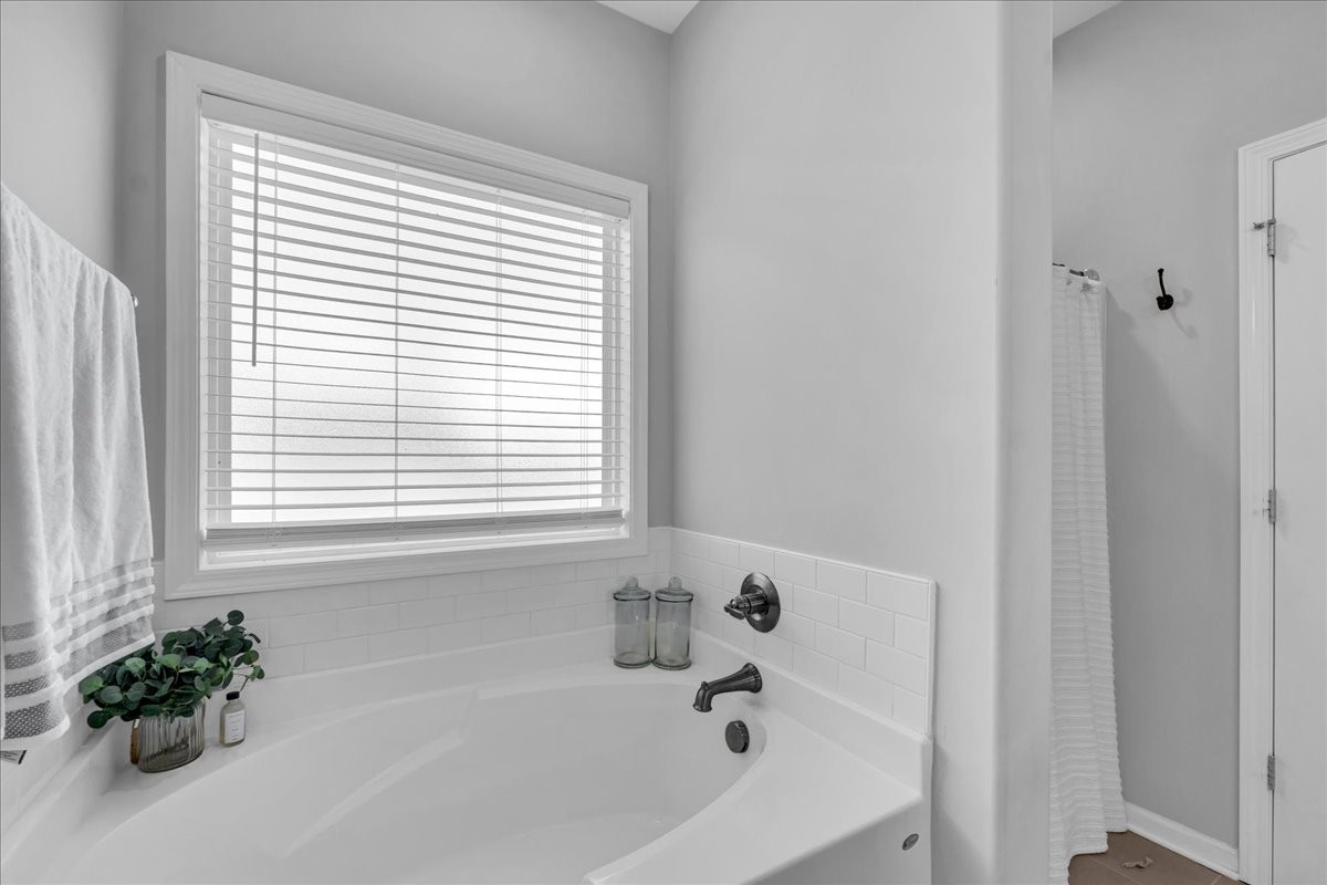 124 Cordell Love Road Smithville, TN 37166 - Photo 39 of 58 a white bath tub sitting in a bathroom next to a window
