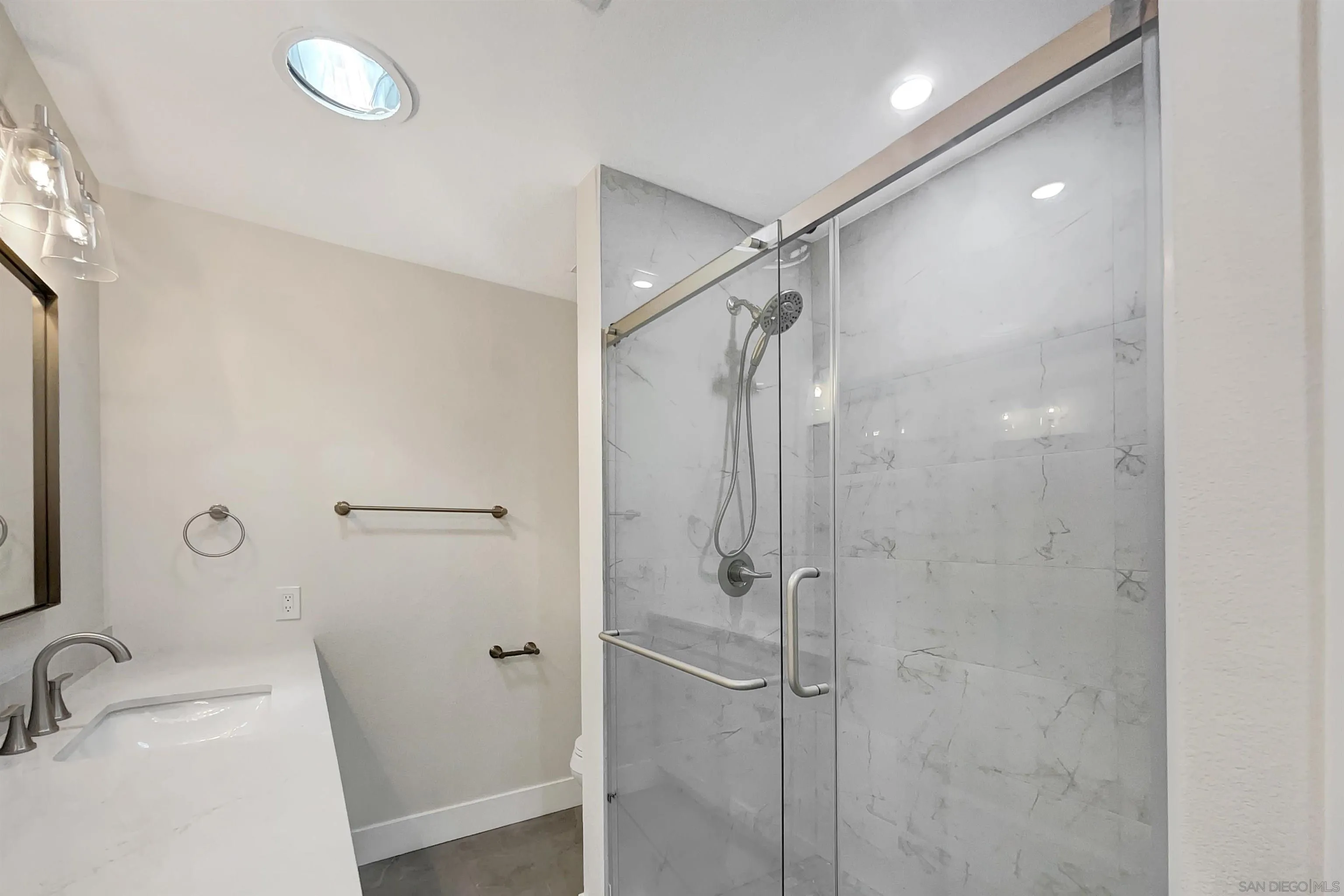 1035 Turnstone Way Oceanside, CA 92057 - Photo 17 of 19 a bathroom with a sink and shower