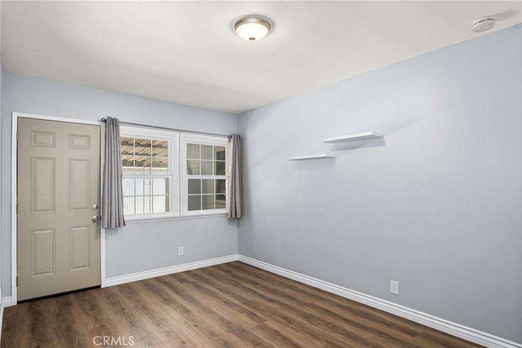2229 Cowlin Avenue Commerce, CA 90040 - Photo 25 of 34 an empty room with wooden floor and windows