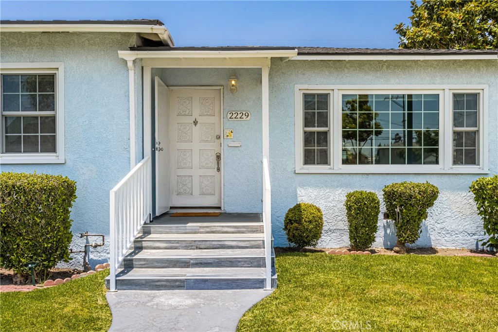 2229 Cowlin Avenue Commerce, CA 90040 - Photo 5 of 34 a front view of a house with a yard
