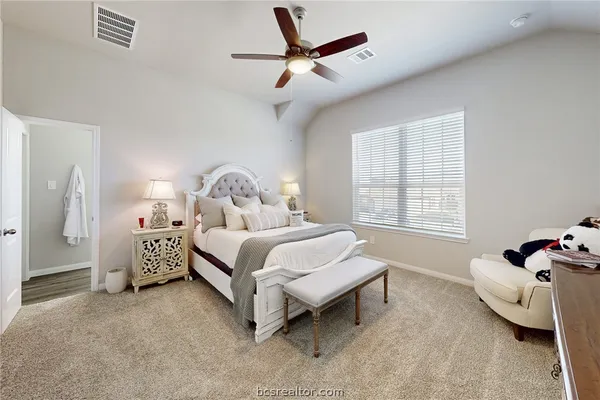a spacious bedroom with a bed and a window