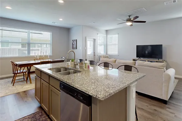 a kitchen with granite countertop a sink and a stove