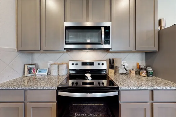 a stove top oven sitting inside of a kitchen