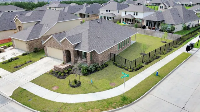 an aerial view of a house with swimming pool and outdoor seating