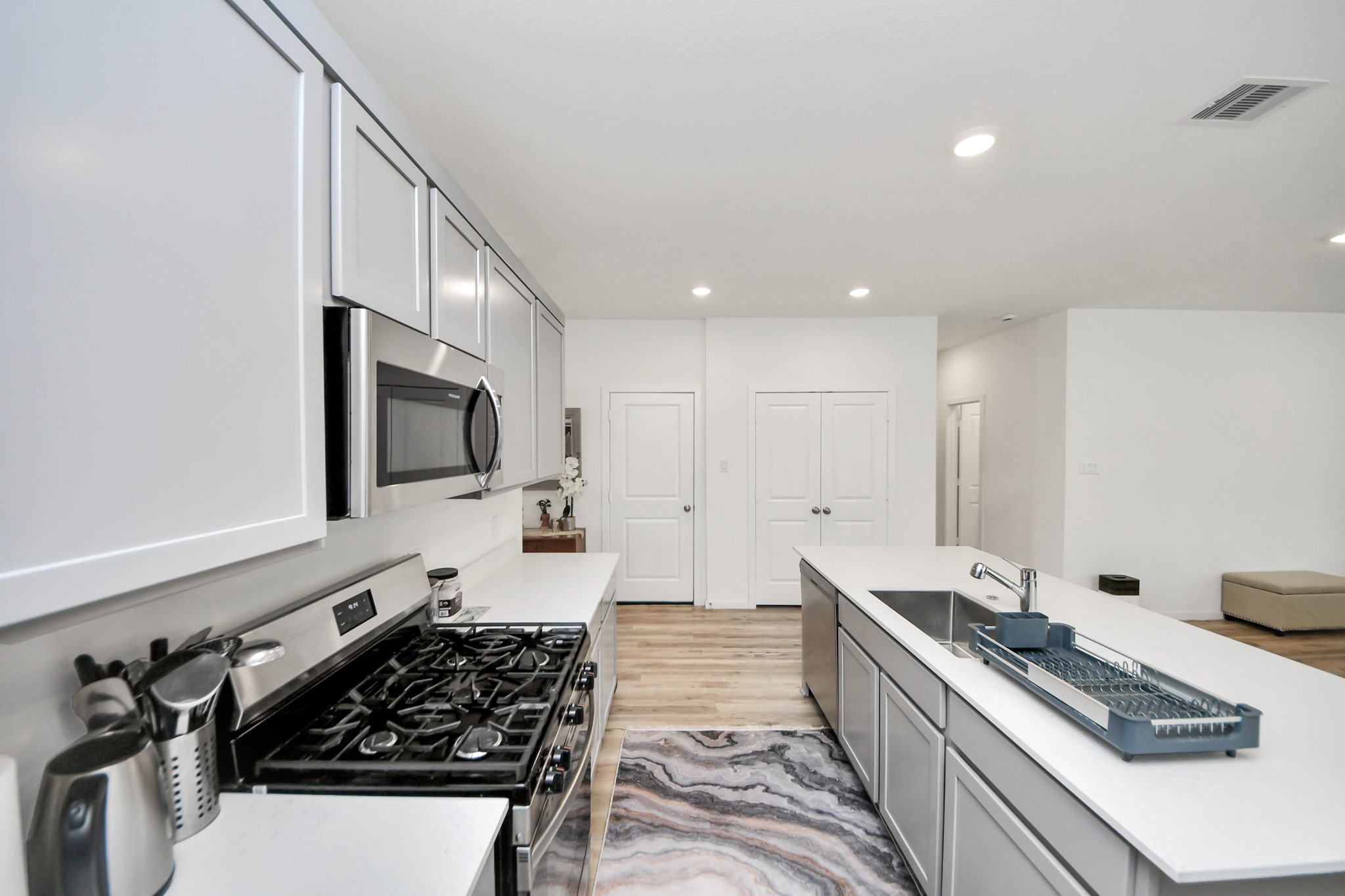 21927 Citrus Grove Cypress, TX 77433 - Photo 15 of 42 a kitchen with stainless steel appliances a sink stove and cabinets