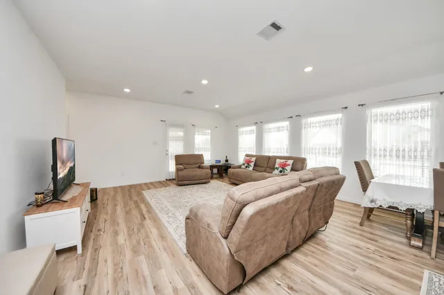 a large bedroom with a bed and large windows