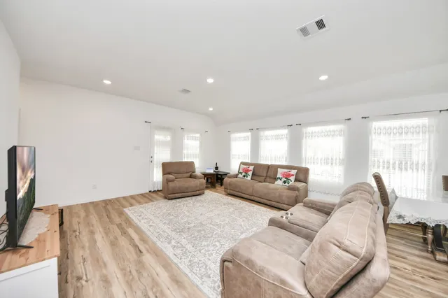 a living room with furniture window and a flat screen tv