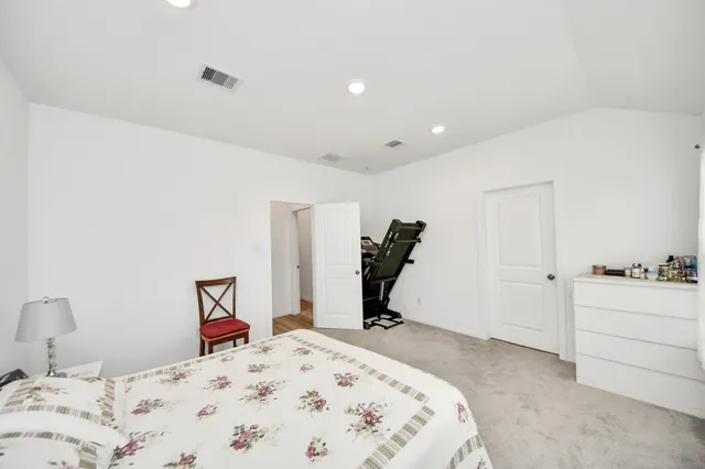 a bedroom with a bed and a chair in it