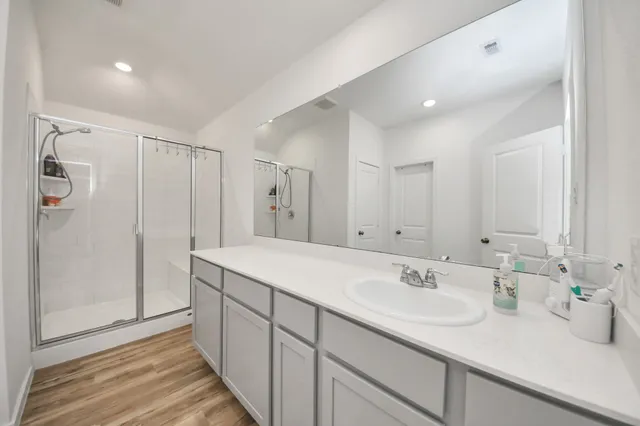 a bathroom with a sink double vanity and shower