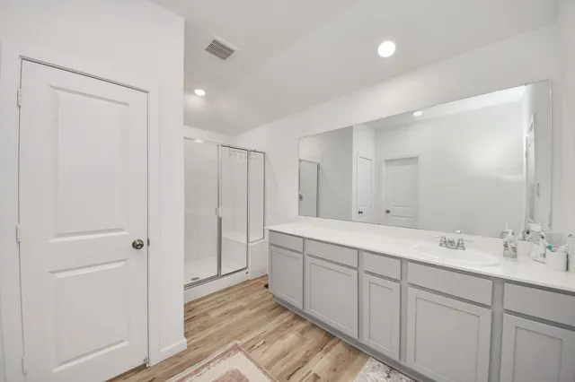 a spacious bathroom with a double vanity sink mirror and