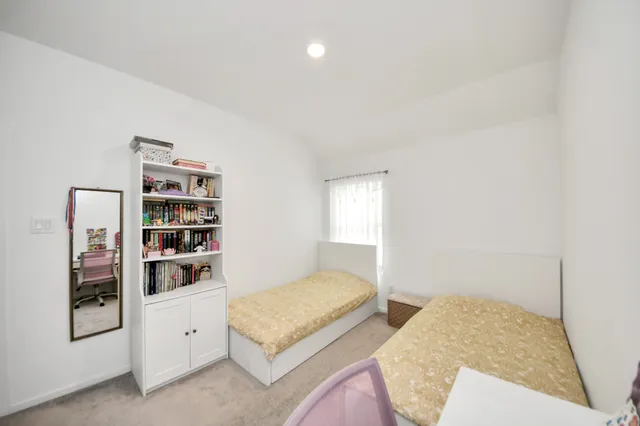 a bedroom with furniture and white walls