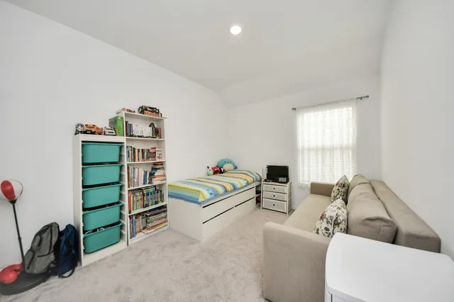 a bedroom with furniture and a book shelf