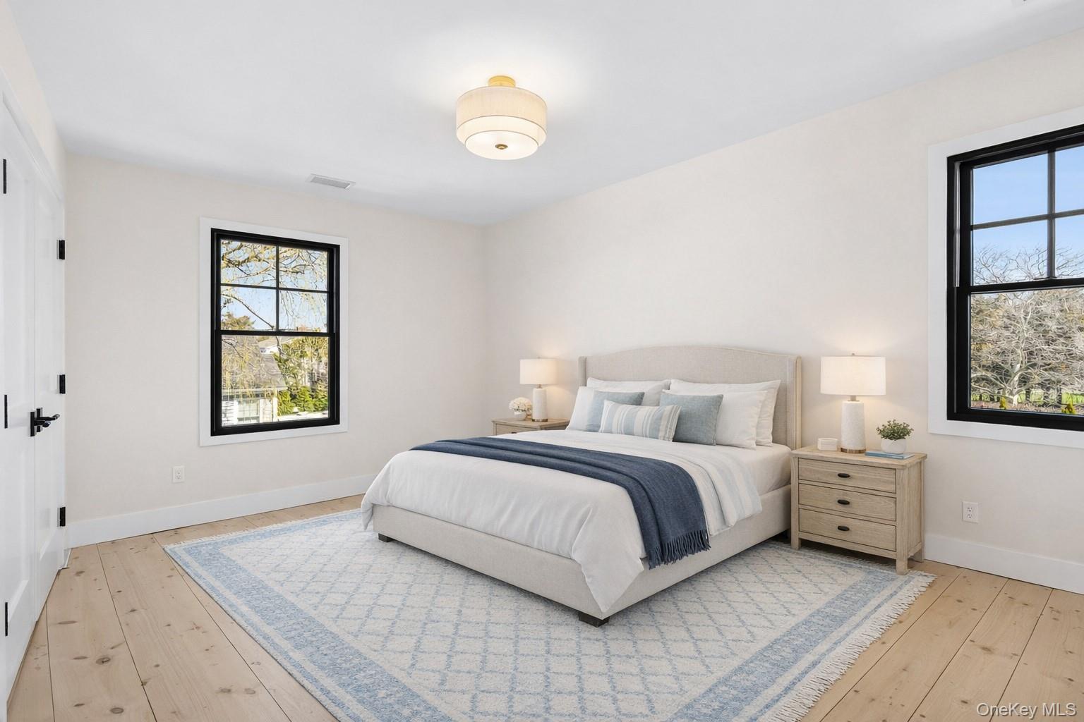 54 Library Avenue Westhampton Beach, NY 11978 - Photo 11 of 21 a bedroom with a bed and a window