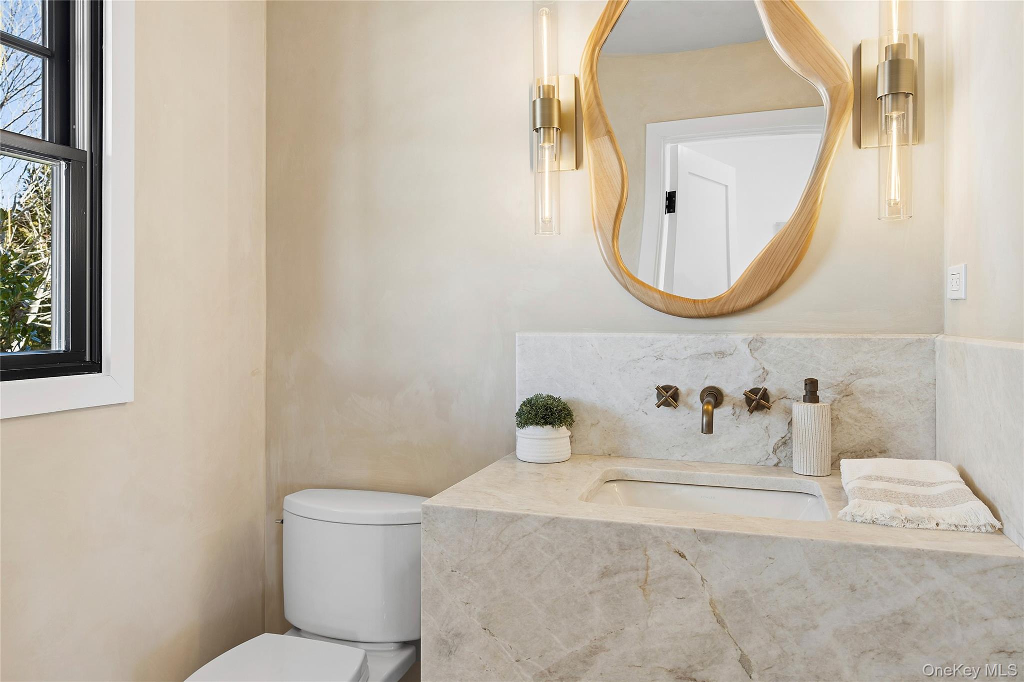 54 Library Avenue Westhampton Beach, NY 11978 - Photo 12 of 21 a bathroom with a sink mirror and toilet