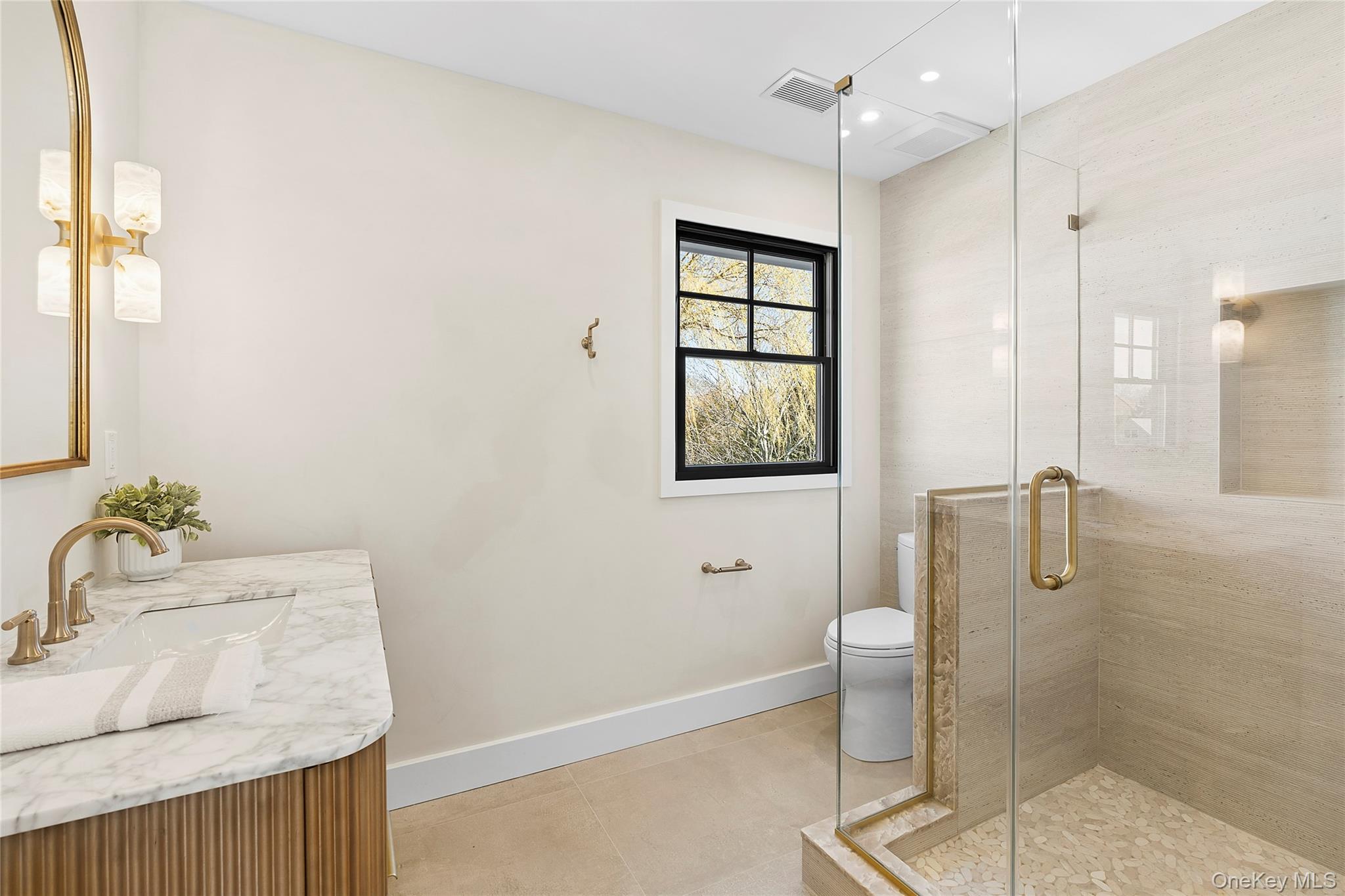 54 Library Avenue Westhampton Beach, NY 11978 - Photo 10 of 21 a bathroom with a granite countertop sink a toilet and shower