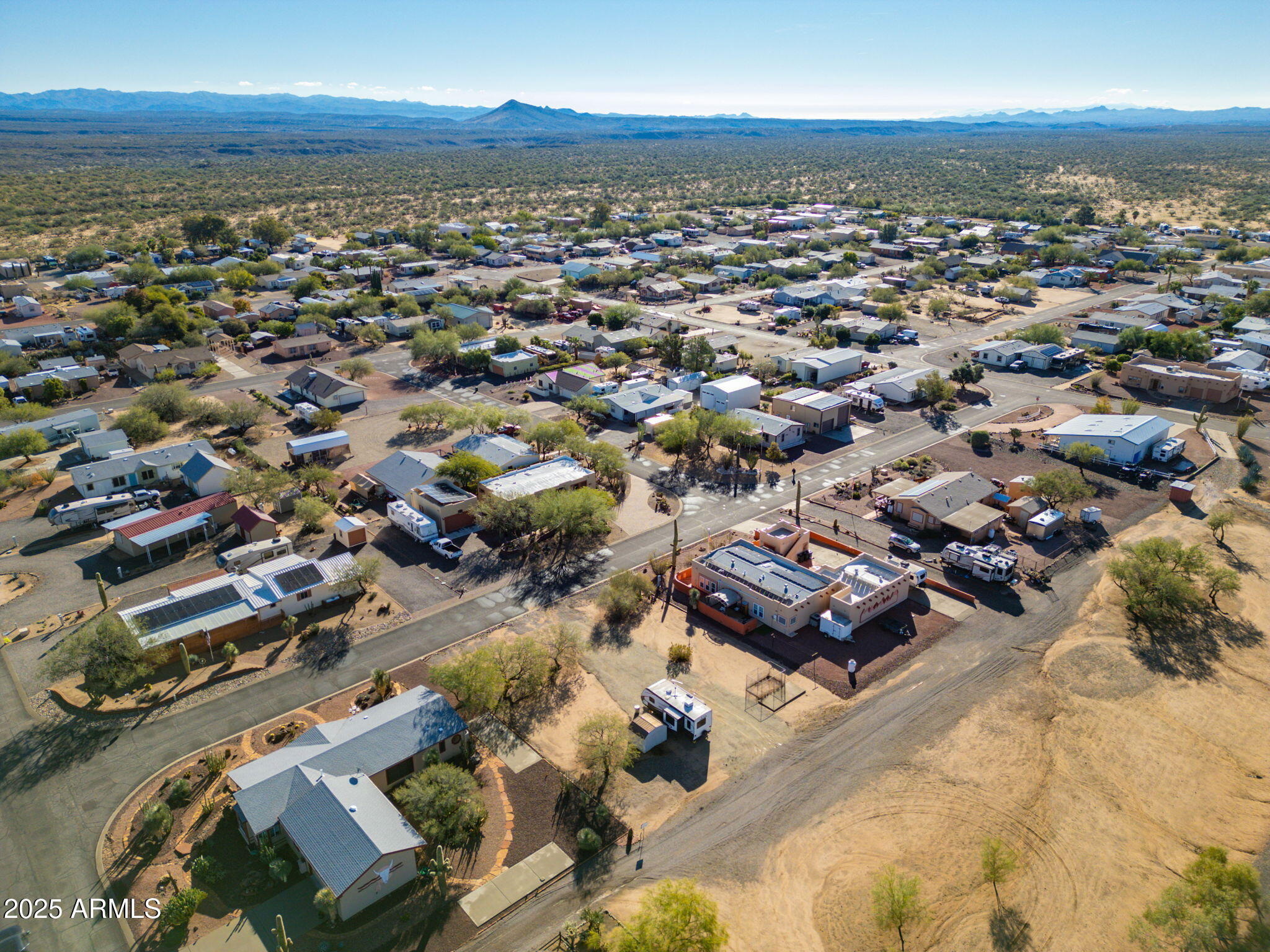 30654 Sun Rider Way, Unit 101 Congress, AZ 85332 - Photo 19 of 28 an aerial view of a city with lots of residential buildings and ocean view in back