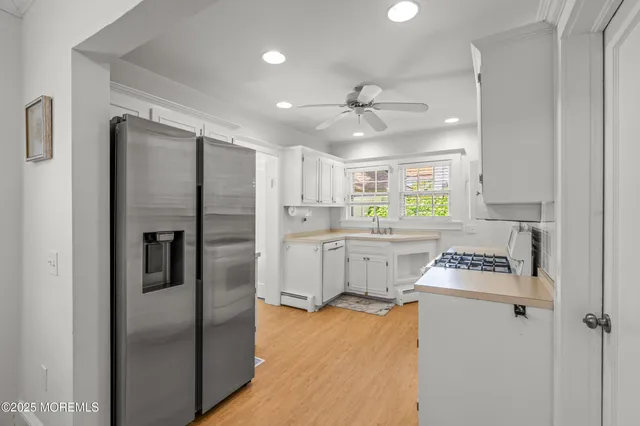 a kitchen with a refrigerator a sink and cabinets